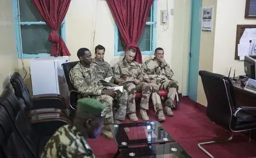American and French soldiers, with a translator working for the American military, attend a daily briefing&nbsp;at a Nigerien military base in Diffa, Niger, March 26, 2015. Image by Joe Penney. Niger, 2015.
