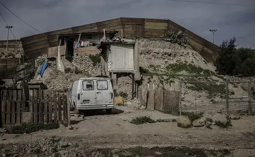 A makeshift house that sits right up against the border wall in Otay Canyon in Tijuana. Image by James Whitlow Delano. Mexico, 2017.