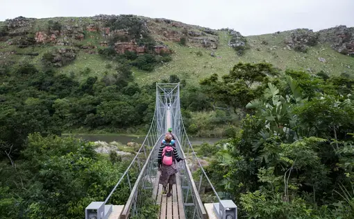 A footbridge over the River Mzamba links Pondoland with the town of Port Edward. Image by Krisanne Johnson for Yale E360. South Africa, 2017. A footbridge over the River Mzamba links Pondoland with the town of Port Edward. Image by Krisanne Johnson for Yale E360. South Africa, 2017.