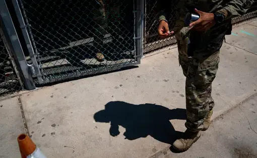 A military police officer leaving the Camp 6 detention center at Guantánamo Bay in April. The most secretive detention area, Camp 7, is off limits to the news media. Image by Doug Mills/The New York Times. Cuba, 2020.