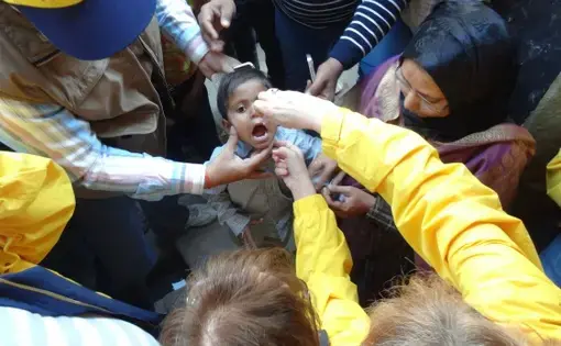 All children under the age of five get two drops of the oral polio vaccine (OPV). Each two-drop dose of the vaccination costs 60 cents. Image by Esha Chhabra. India, 2013. Media file: DSC00136.JPG