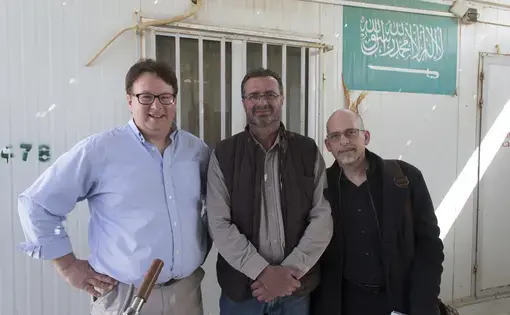 Ihab Muhtaseb (center) is shown with Milwaukee Journal Sentinel staffers Mark Hoffman (left) and Mark Johnson Wednesday, March 22, 2016 at the Zaatari refugee camp in Jordan about 15 miles from the Syrian border. Muhtaseb was an interpreter for the pair. Image by Mark Hoffman. Jordan, 2016. Media file: jordan_day_five_blog.jpg