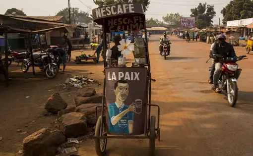 A coffee cart in Bangui, one of many wheeled around the bustling, dusty capital city. The front reads "La Paix" - "Peace". Image by Jack Losh. Central African Republic, 2018.