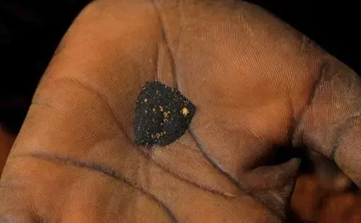 Woman holding gold deposits. Image by Ben Depp. Haiti, 2012.