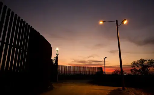 The border fence and levee pass through the Lower Rio Grande Valley National Wildlife Refuge in Hidalgo. Image by Callie Richmond. United States, 2017.