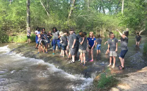 Elementary school students play in the water at the Chickasaw National Recreation Area near Sulphur, Oklahoma. After the state of Oklahoma experienced an extended drought in 2011-2012, officials put together a drought mitigation plan for this region. Image by Lenzy Krehbiel-Burton / Harvest Public Media. United States, 2020.
