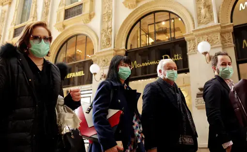 Tourists in face masks at the Wiktor Emanuel II Gallery in Italy. Image by Praszkiewicz / Shutterstock. Italy, 2020.