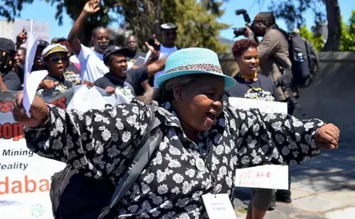 A delegate of the Alternative Mining Indaba dances during a protest march in Cape Town, South Africa, in February. Image by Mark Olalde. South Africa, 2017.