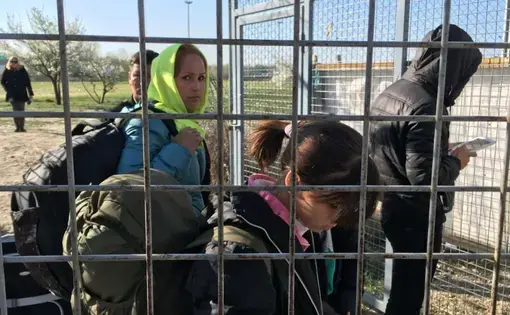 An Afghan refugee family enters Hungary from Serbia.  Under a controversial new Hungarian border law, they live in a detention camp at the border until their case is decided. Image by Jeanne Carstensen. Hungary, 2017.