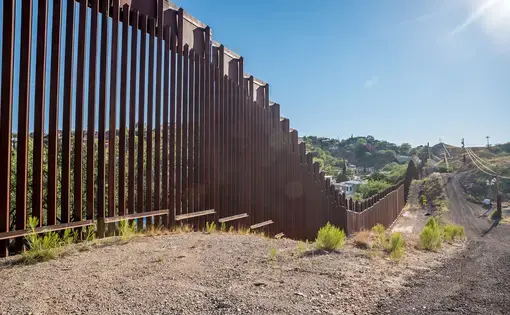Border fence between United States and Mexico in Nogales, Arizona. Image by Shutterstock. United States, 2017.