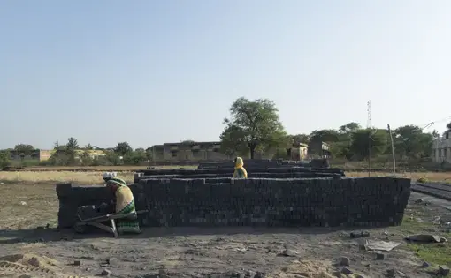 Women working at a small, temporary brick factory in Malda village. While most of the laborers at this factory were local relatives of the owner, the industry is notorious for exploiting migrant labor. Image by Yardain Amron. India, 2016.