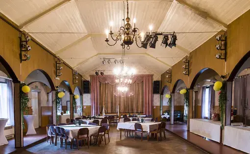 The East German-era banquet hall in Amt Neuhaus where more than 400 locals gathered in October 2015 to debate the arrival of refugees in Sumte. The hall was a chaotic scene, with journalists, far-right agitators, and many worried villagers who wanted to know what the arrivals would mean. Image by Valerie Schmidt. Germany, 2017.