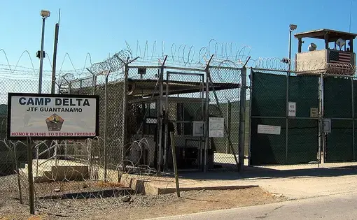 The entrance to Camp 1 in Guantanamo Bay's Camp Delta. The base's detention camps are numbered based on the order in which they were built, not their order of precedence or level of security. Image by Kathleen T. Rhem/Wikimedia Commons. Cuba, 2005.