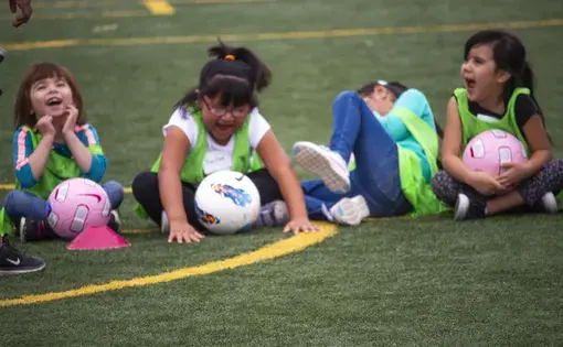 Students prepared for a scrimmage during the soccer clinic at Carroll Elementary School in Bernalillo, New Mexico. They laughed as their classmates were counted off into groups by fruit names like banana, strawberry, and apple. Image by Viridiana Vidales Coyt. United States, 2017.