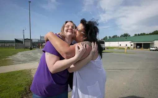Tera Crowder hugs her mother Deborah after being released from the Fluvanna Correctional Center for Women in June 2019. Image by Julia Rendleman. United States, 2019.