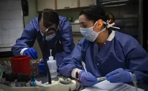 U.S. Navy Hospital Corpsman 3rd Class Janet Rosas (right,) and Hospital Corpsman 2nd Class Cecil Dorse test blood samples aboard the Military Sealift Command hospital ship USNS Comfort in New York City. Image courtesy of U.S. Navy Mass Communication Specialist 2nd Class Sara Eshleman. United States, 2020.