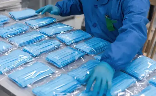 With the global spread of novel coronavirus, medical mask production workers are organizing masks to prepare for the epidemic. Image by InkheartX / Shutterstock.