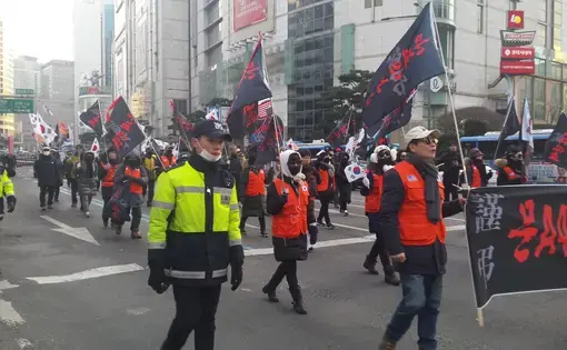 South Korean conservatives march through the streets of downtown Seoul in February in protest of their liberal president's diplomatic outreach to North Korea. Image by Rachel Oswald. South Korea, 2018.