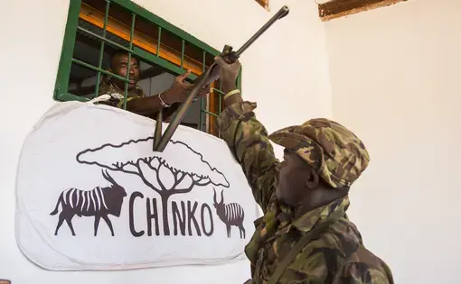 Returning from patrol, a ranger hands in his weapon to Chinko’s armory. Image by Jack Losh. Central African Republic, 2018.