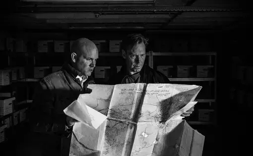 Chris Engels and Bill Wiley examine a tracer map inside the evidence room of the Commission for International Justice and Accountability. Image by Ben Taub. Europe, 2016. Media file: 160106_head_of_regime_crimes_and_director_1.jpg
