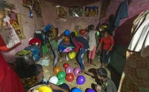 In this April 3, 2020, photo, Rajesh Dhaikar's children play with balloons in their house in Prayagraj, India. Dhaikar has a small balloon stall in a nearby market, selling plastic bursts of red and blue and yellow one at a time, and rarely earning more than $2.50 a day. His wife, Suneeta, makes about $20 a month cleaning homes. They have five children, ranging in age and a bank account with about $6.50 in it. India has launched one of the most draconian social experiments in human history, locking down…