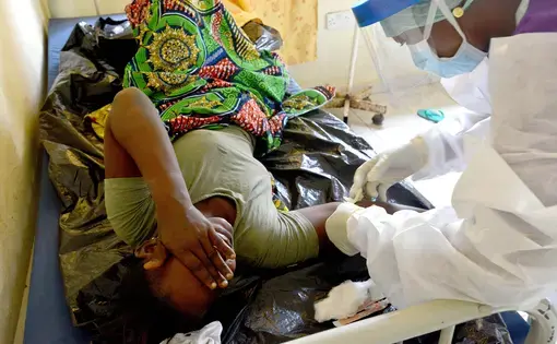 KONO DISTRICT - SIERRA LEONE Aminata Kamara, 25, is prepped for a blood transfusion during treatment for uncontrolled bleeding at Kono Government Hospital in Sierra Leone's rural Kono District on March 30, 2015. Two days earlier Kamara underwent surgery to have her dead fetus removed. Image by Michael G. Seamans. Sierra Leone, 2015. Media file: healthcare_sierra_leone_009.jpg