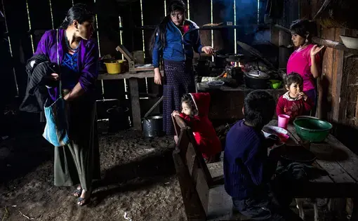 María García Domingo, 33, leaves home to go to work  in the coffee harvest, while her 5 daughters and one son have breakfast. Her husband recently left for the U.S. which means García Domingo now has to work more out in the fields while her daughters take care of the house. Image by Simone Dalmasso /The Arizona Daily Star. Guatemala, 2019.