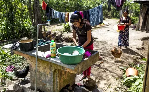 Candelaria López, 15, washes dishes in her front yard in Bulej. Image by Simone Dalmasso/Arizona Daily Star. Guatemala, 2019.