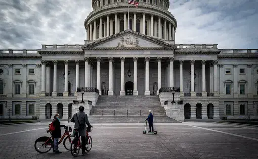 On a day when nearly every museum and landmark was closed due to COVID-19, tourists use rental bikes and scooters to view the outside of the U.S. Capitol. Image by Phil Roeder / Flickr. United States, 2020.
