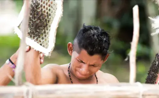 Benito Miquiles endures the Waumat ritual for the fifteenth time in his life; he will participate in the rite 5 more times to prepare himself for his role as a Sateré leader. Image by Matheus Manfredini. Brazil, 2019.