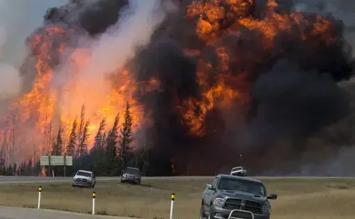 A wildfire burns near Fort McMurray, Alberta, Canada, on May 7. Image courtesy of Premier of Alberta/flickr.