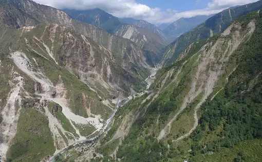 The mountainsides, severely weakened by last year’s Gorkha Earthquake, is more likely to give way, especially during monsoons and aftershocks. Image by Kristen Cook. Nepal, 2015. Landscape badly scarred by last year's quake