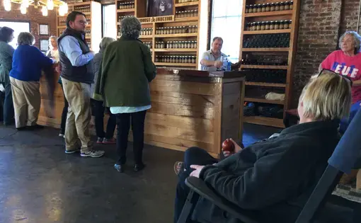 Leverett and Letcher County residents gather at Kentucky Mist Moonshine in Whitesburg, Ky. Image by Richie Davis. United States, 2018.
