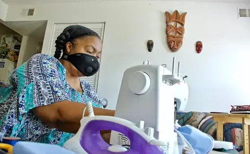 Kim Daniel makes her own masks for her protection at her home in Preservation Square. Image by Wiley Price / St. Louis American. United States, 2020.