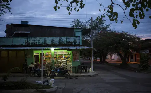 Men enjoy an evening snack at a small shop in Vista Hermosa, Meta, Colombia on Thursday, March 8, 2018. Image by&nbsp;Greg Kendall-Ball. Colombia, 2018.