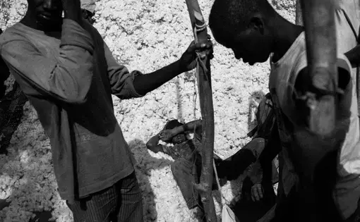 Local farmers are seen at the so-called market, a collection center for cotton, in a village near Dano. Image by Jošt Franko. Burkina Faso, 2015.