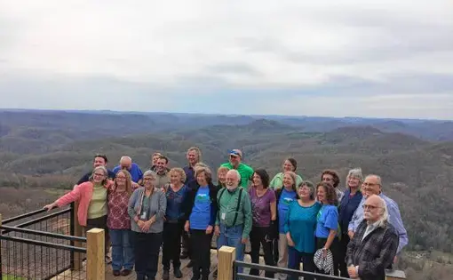Residents of Leverett and Letcher County, Kentucky pose for a photo together at Hogg Mountain at the end of their four-day visit together. Image by Richie Davis. United States, 2018.
