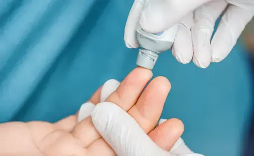 A doctor tests a patient's blood at the hospital. Image via Shutterstock.