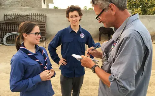 Scouts Miciah Thacker and Chris Sherman learn interviewing techniques from National Geographic Fellow Paul Salopek during a visit in northern India. Image by Mark Schulte. India, 2018.