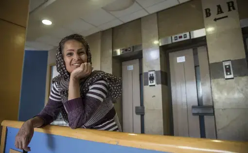 Jamila, an asylum-seeker from Iran and mother of four, is now staying with her children and grandchildren at the City Plaza Hotel in Athens, home to 300-plus immigrants, many of whom were staying in camps before the hotel was established as an alternative. Image by Jodi Hilton. Greece, 2016. Media file: jodihilton3.jpg