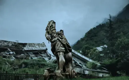 A broken statue of Da Yu, the god-king who tamed the long-term flooding of China’s rivers, in front of the collapsed Beichuan county-government building. Both were damaged in the 2008 earthquake. Image by Sim Chi Yin/VII Photo. China, 2015.