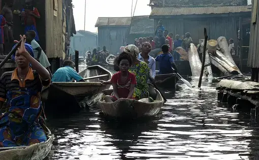 Boats traverse a canal in Makoko, Nigeria. Image by Heinrich-Böll-Stiftung / Wikimedia Commons. Nigeria, 2010.