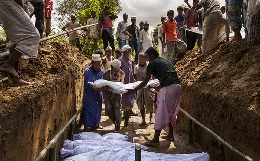 Bengali residents from the nearby Inani village donated the land and dug the mass grave for the 15 bodies recovered near their Inani Beach. Of the more than 100 Rohingyas from a boat that had capsized in the Bay of Bengal, only 17 people survived. Image by Patrick Brown/Panos Pictures/UNICEF. Bangladesh, 2017.