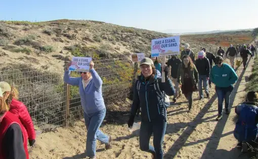 Protesters against beach sand mining near Monterey, California, head to the site of the mine. Image by Adara Shilling. United States, 2017.