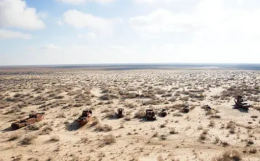 Rusting ships sit in the desert in the former port of Moynaq, Uzbekistan. Today, Moynaq is almost 100 miles from the receding shore of the southern Aral Sea. Image by Taylor Weidman. Uzbekistan, 2018.
