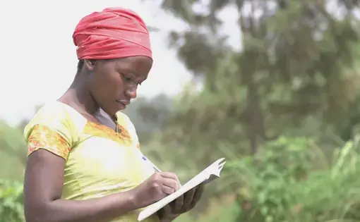 In Rwanda, women are becoming leaders in what were once male-dominated professions. Here Jacqueline Mukamunana, secretary of the Duteraninkunga cassava cooperative, takes attendance. Image by Cammie Behnke. Rwanda, 2018.