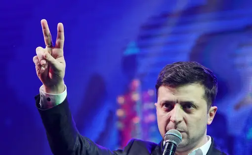 Ukrainian President-elect Volodymyr Zelenskiy shows victory sign during a comedy show at a concert hall in Brovary. Ukraine, 2019. Image by Shutterstock.