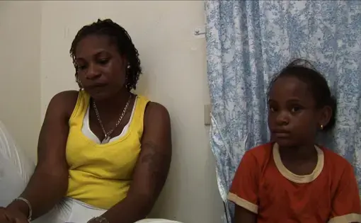 Simone and her daughter Khayla in hiding at a safe house outside of Kingston, Jamaica. Image by Micah Fink. Jamaica, 2009. Media file: simone_pic.jpg