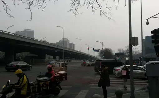 An intersection in Beijing. The pollution that shrouds China’s cities kills an estimated 1.1 million people every year. Image by Beth Gardiner. China, 2017.