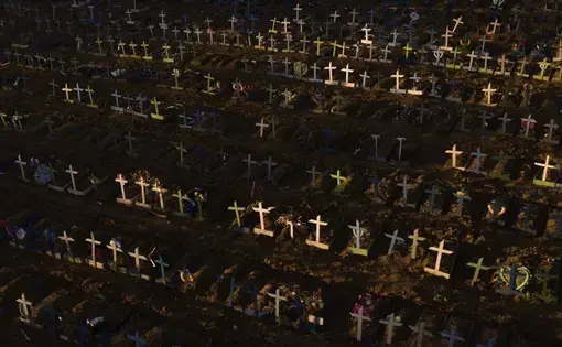 Crosses mark the graves of those who have passed away since early April, filling a new section of the Nossa Senhora Aparecida public cemetery amid the new coronavirus pandemic in Manaus, Brazil, Sunday, May 16, 2020. Image by Felipe Dana / AP Photo. Brazil, 2020.
